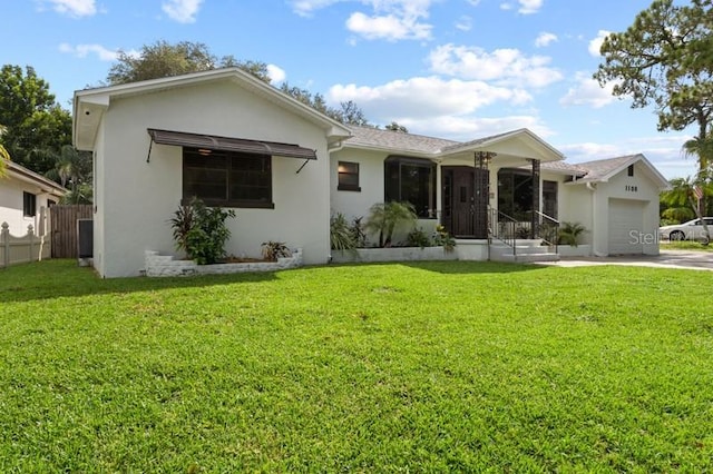 ranch-style home featuring a front yard and a garage