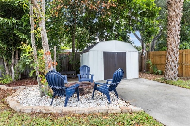 view of patio / terrace with a fire pit and a storage shed