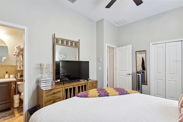 bedroom with ceiling fan, a closet, and ensuite bathroom