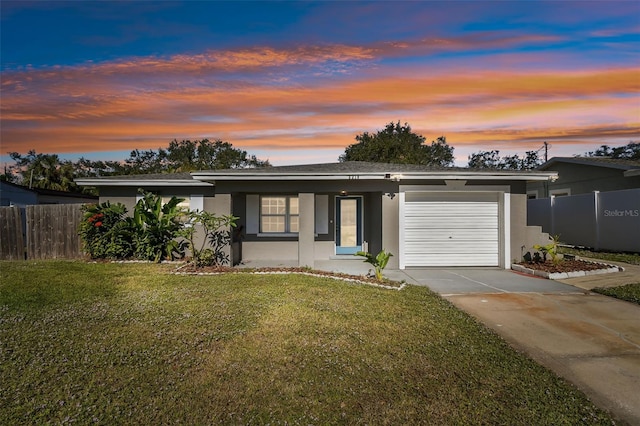 view of front facade with a lawn and a garage