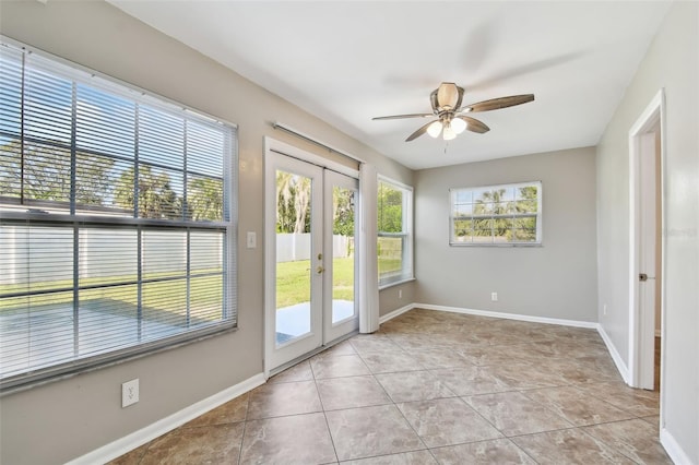 entryway with ceiling fan, plenty of natural light, light tile patterned floors, and french doors