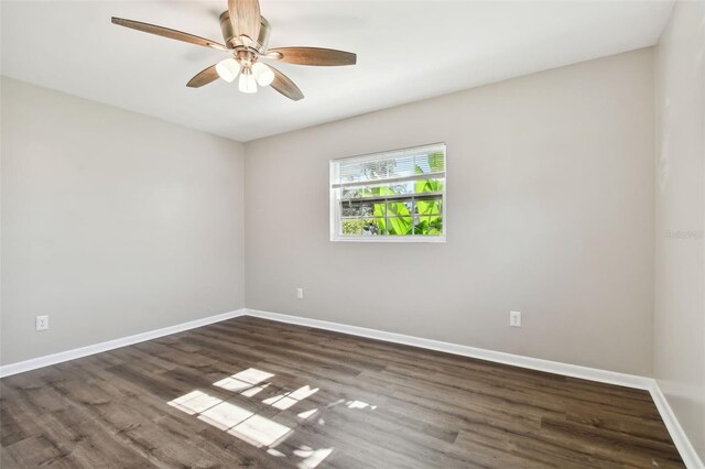 empty room with dark hardwood / wood-style floors and ceiling fan