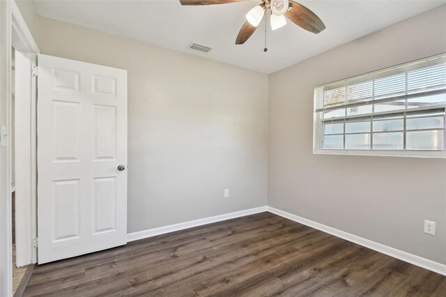 spare room featuring dark hardwood / wood-style floors and ceiling fan