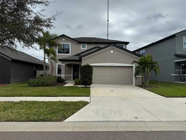 front facade with a front lawn and a garage