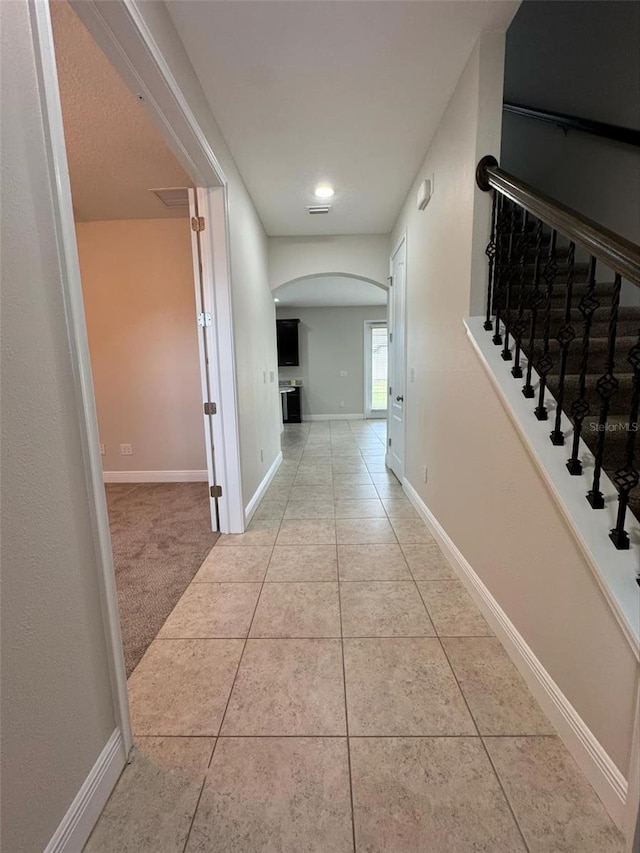 hall with light tile patterned flooring