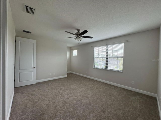 spare room featuring carpet, a textured ceiling, and ceiling fan