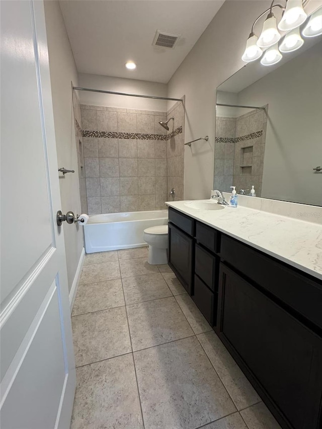 full bathroom featuring tile patterned floors, vanity, toilet, and tiled shower / bath