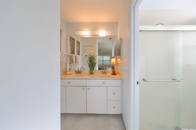 bathroom with vanity and a textured ceiling