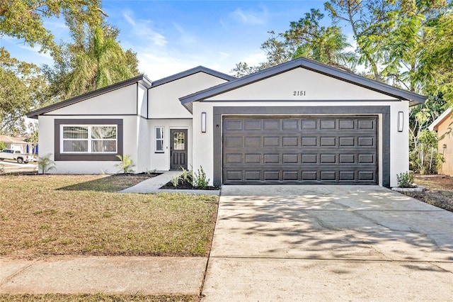 ranch-style home with a front lawn and a garage