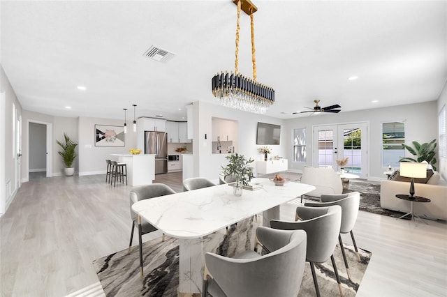 dining area featuring ceiling fan, french doors, and light hardwood / wood-style floors