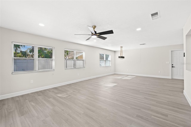 unfurnished room featuring ceiling fan and light hardwood / wood-style floors