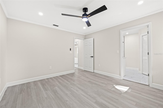 unfurnished bedroom featuring light wood-type flooring, ceiling fan, crown molding, and connected bathroom