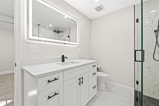 bathroom featuring vanity, a shower with shower door, and toilet