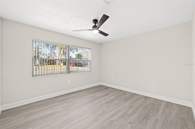 unfurnished room featuring ceiling fan, light hardwood / wood-style floors, and a textured ceiling