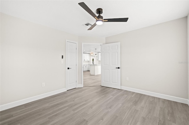 unfurnished bedroom featuring ceiling fan and light hardwood / wood-style flooring