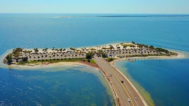 birds eye view of property featuring a water view and a beach view