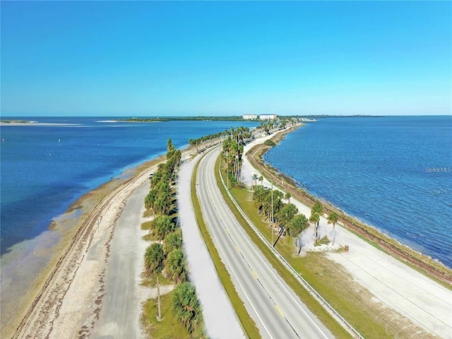 drone / aerial view featuring a beach view and a water view