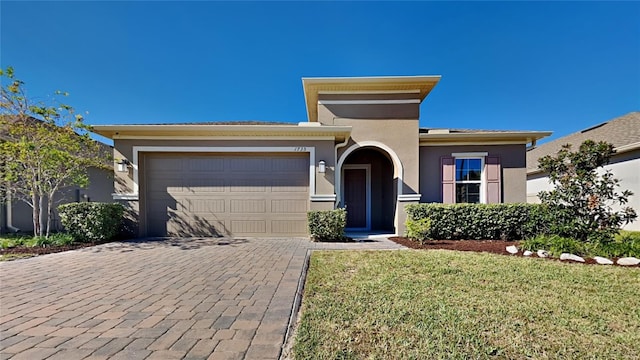 view of front of home featuring a front yard and a garage