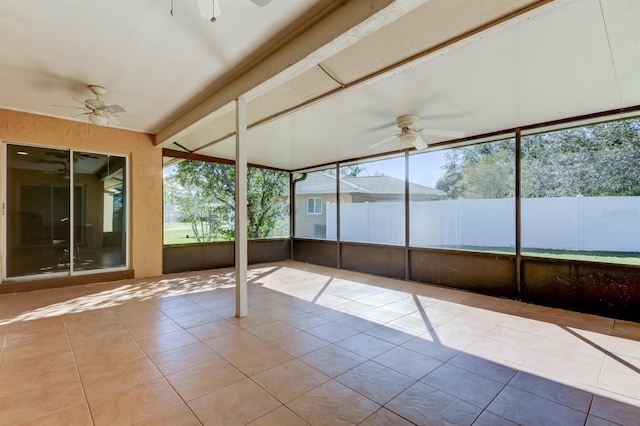 unfurnished sunroom with beamed ceiling