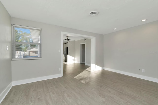 empty room with hardwood / wood-style floors and ceiling fan