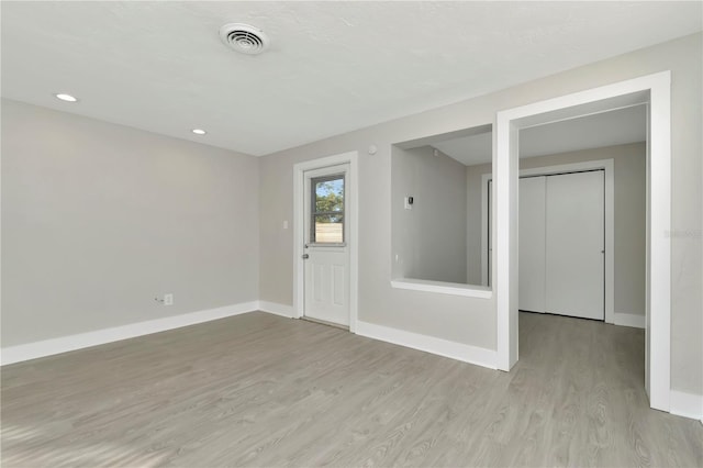 unfurnished room with light wood-type flooring