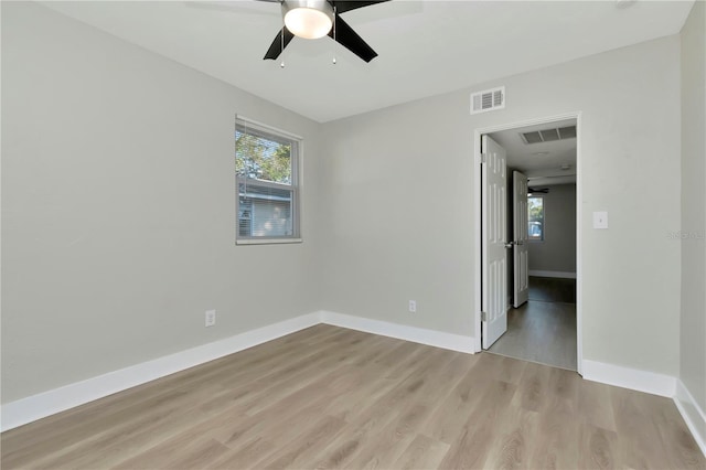 spare room with ceiling fan and light wood-type flooring