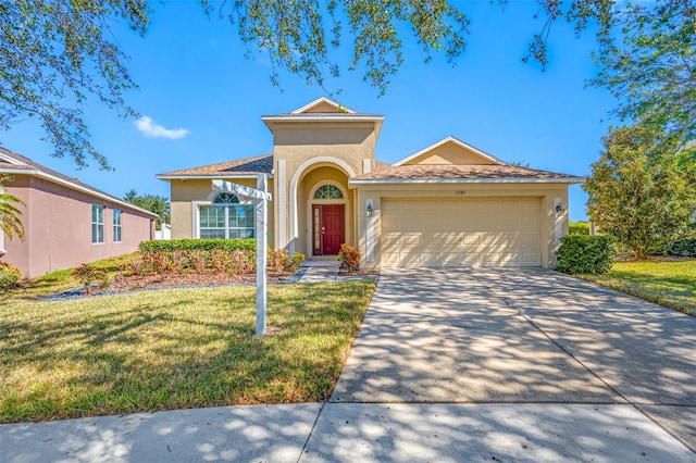 view of front of property featuring a front yard and a garage