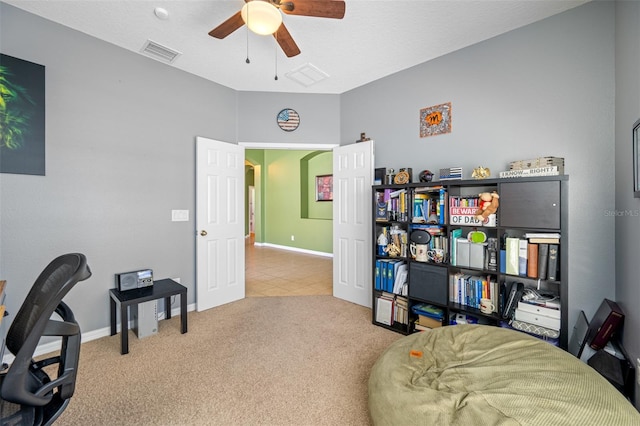 office space with a textured ceiling, carpet floors, and ceiling fan