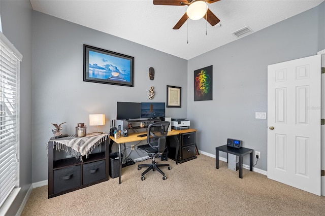 carpeted home office featuring ceiling fan