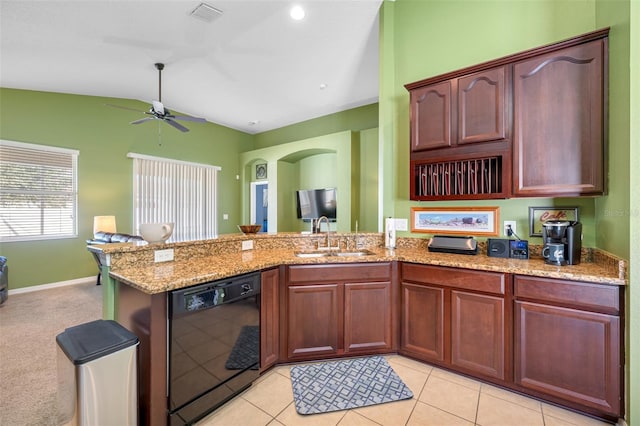 kitchen featuring dishwasher, light tile patterned floors, lofted ceiling, and sink