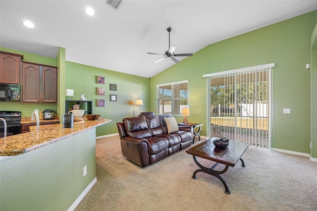 living room featuring light carpet, ceiling fan, and vaulted ceiling