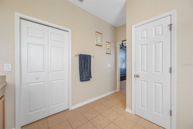 interior space with light tile patterned flooring and a textured ceiling