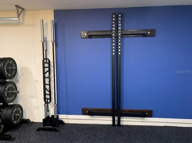 workout area featuring a textured ceiling