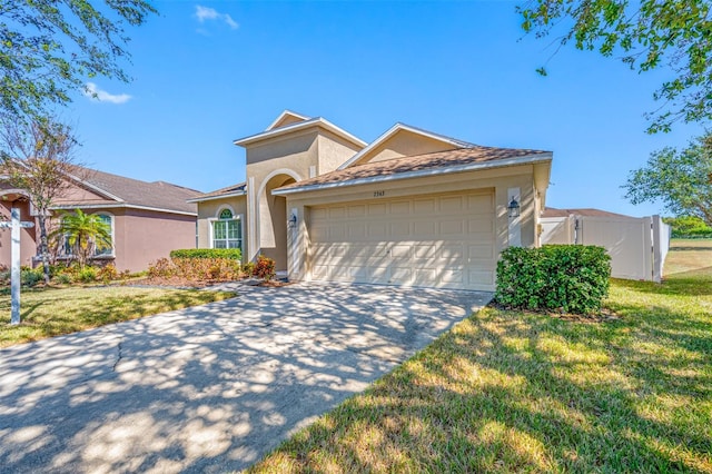 ranch-style home with a front yard and a garage