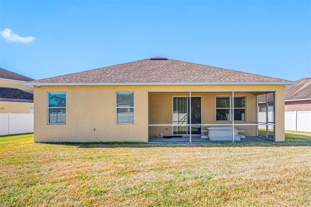 back of property featuring a sunroom and a yard