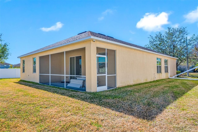 view of side of home with a yard