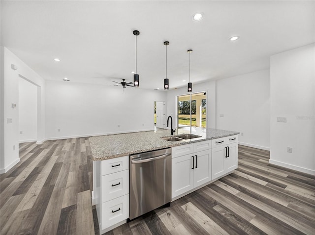 kitchen with light stone countertops, white cabinetry, sink, hanging light fixtures, and stainless steel dishwasher