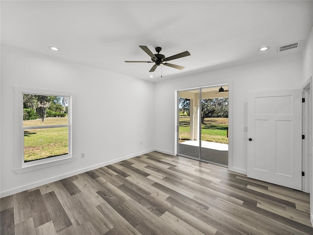 empty room with ceiling fan and wood-type flooring