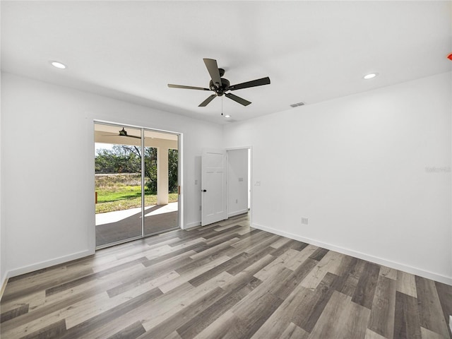 spare room featuring light wood-type flooring and ceiling fan