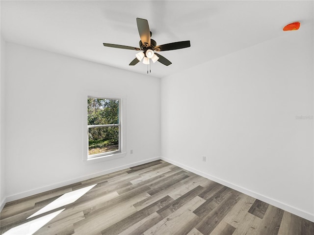 spare room with ceiling fan and light hardwood / wood-style flooring