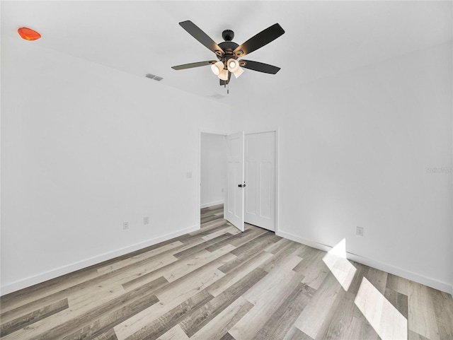 empty room with light wood-type flooring and ceiling fan