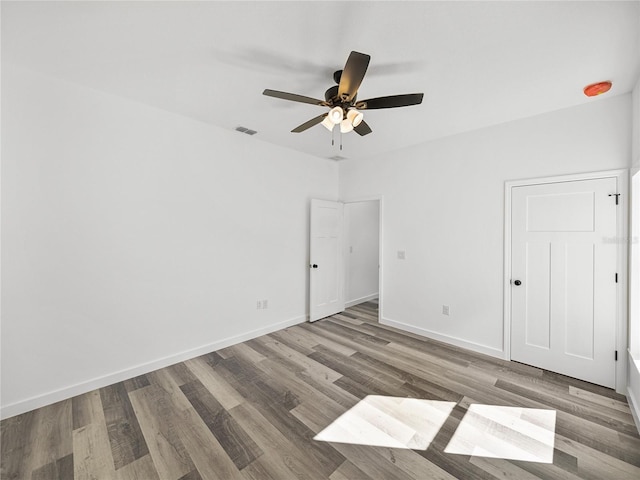 empty room with wood-type flooring and ceiling fan