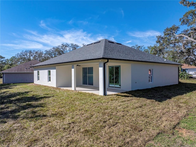 back of house featuring a patio area and a yard