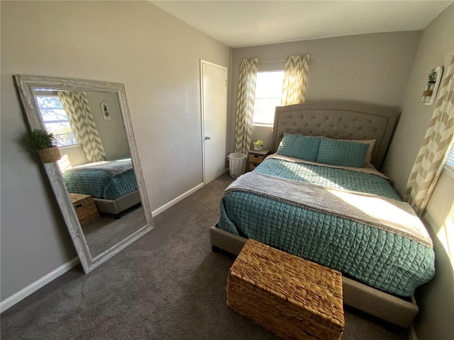 bedroom with dark colored carpet