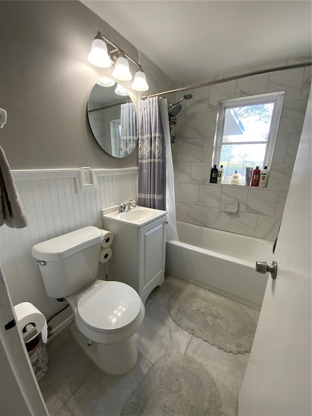 full bathroom featuring tile patterned floors, vanity, toilet, and shower / bath combo with shower curtain