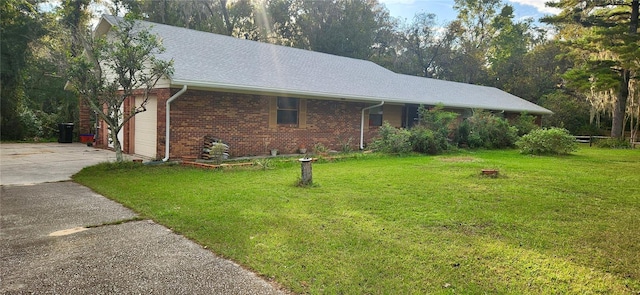 ranch-style house with a front yard and a garage