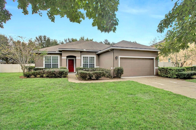 ranch-style house featuring a garage and a front lawn