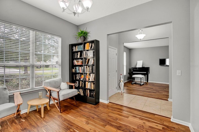 living area featuring hardwood / wood-style floors and an inviting chandelier