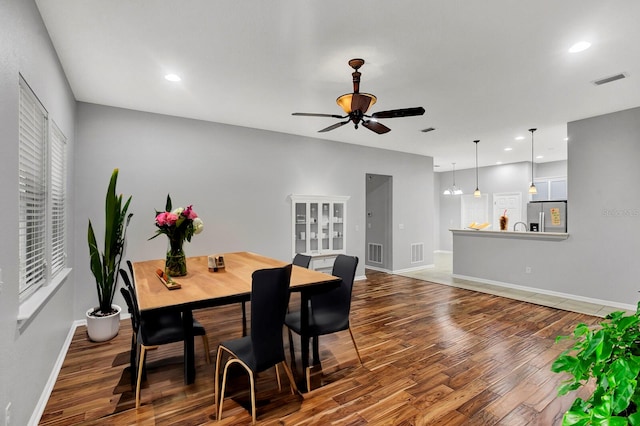 dining space with hardwood / wood-style flooring and ceiling fan