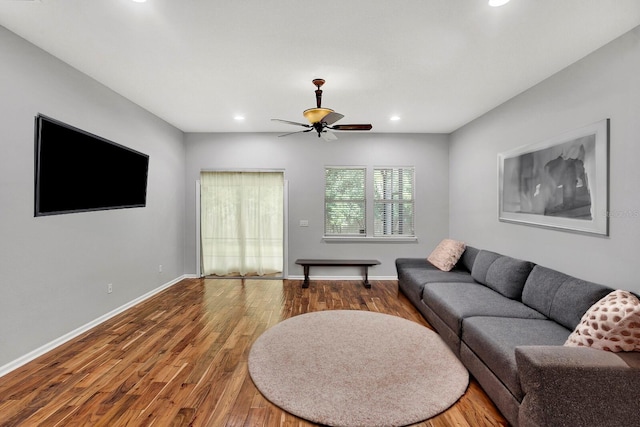 living room with hardwood / wood-style flooring and ceiling fan